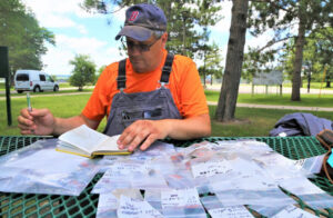 CEMML Archaeologist, Bill Thompson examines artifacts at Fort McCoy